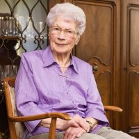 91-years-old-senior-woman-sitting-armchair-her-living-room